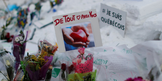A card saying "With you with all of our hearts" is pictured at the memorial near the site of a fatal shooting at the Quebec Islamic Cultural Centre in Quebec City, Canada January 31, 2017. REUTERS/Mathieu Belanger