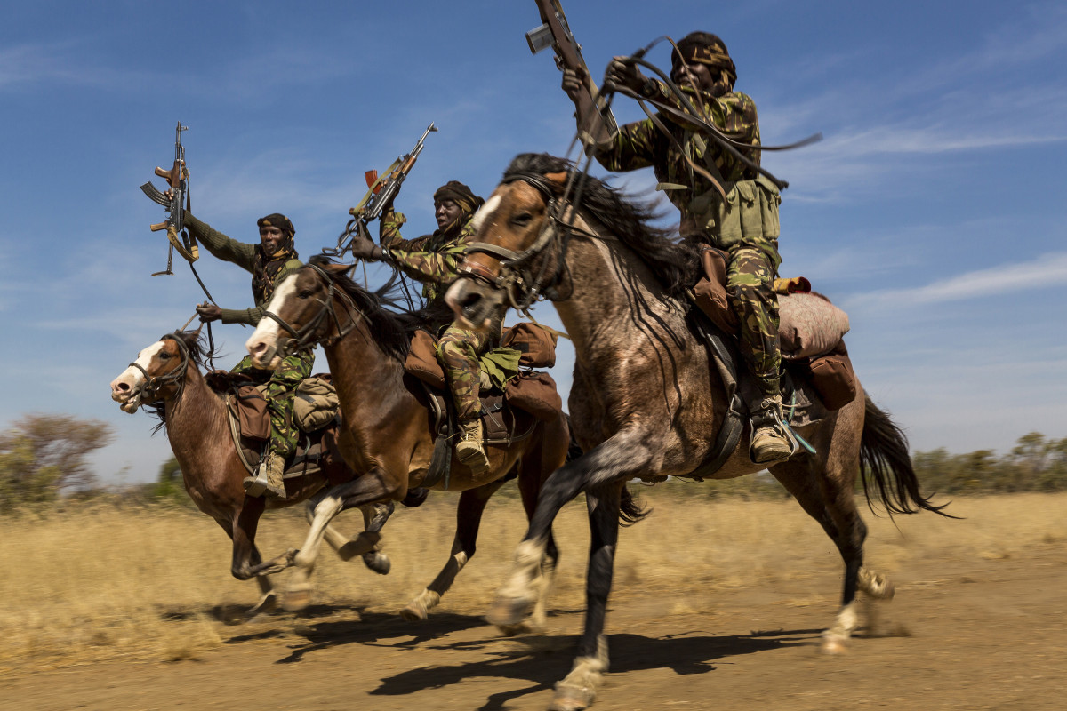 ZAKOUMA NATIONAL PARK, CHAD: Rangers from a horse patrol group exhibit their riding skills as they return to base at Zakouma National Park, Chad after weeks on elephant patrol. The horse patrols are the old guard of Zakouma's rangers and have seen a good deal of conflict in their time in the park. Zakouma lost nearly 75% of its elephants in the decade before 2011 due to raids by Janajaweed and Sudanese poachers, many of them from the Sudanese military. The president of Chad, Idris Deby, is a big supporter of the elephant of Zakouma and of its elephants. The herds here until recently used to be as large as 1000 animals all moving together, severe poaching over the last decade saw that number decimated and now only around 10% of the number remains. Since 2011 however there has been control over poaching and only 3 elephant have been poached in the last 2 years. The credit for that lies with these rangers and the new management of the park, including nomad groups who are a vital part of intelligence gathering for Zakouma.